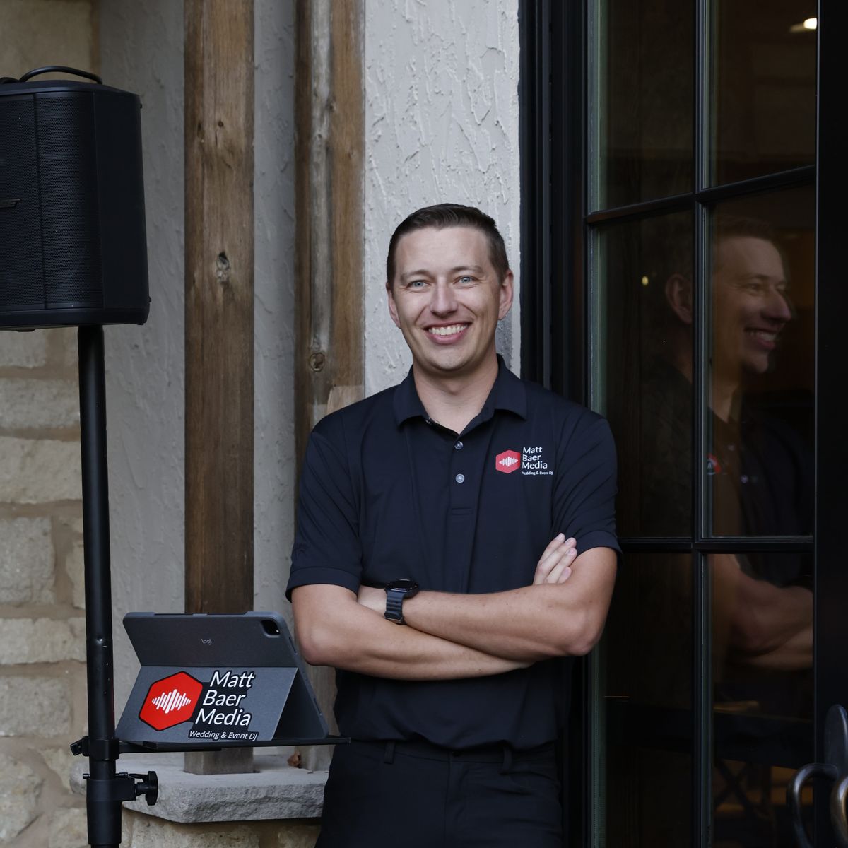 Matt Baer standing next to his DJ setup